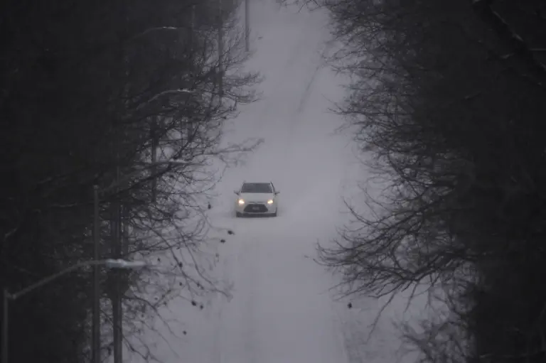 A-motorist-drives-down-a-snow-covered-street-as-a-winter-storm-passes-though-the-area-Saturday-Jan-24-2026-in-Kansas-City-Mo