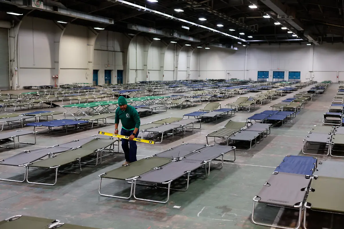 Volunteers-prepare-cots-at-an-inclement-weather-shelter-ahead-of-a-winter-storm-at-Fair-Parks-Automobile-Building-in-Dallas-Texas-US-on-Friday-Jan-23-2026-Texas-Governor-Greg-Abbott-issued-disaster-declarations-for-more-than-half-the-counties-in-the-state-ahead-of-a-powerful-winter-storm-that-will-be-one-of-the-toughest-tests-of-the-electric-grid-since-a-deadly-2021-collapse