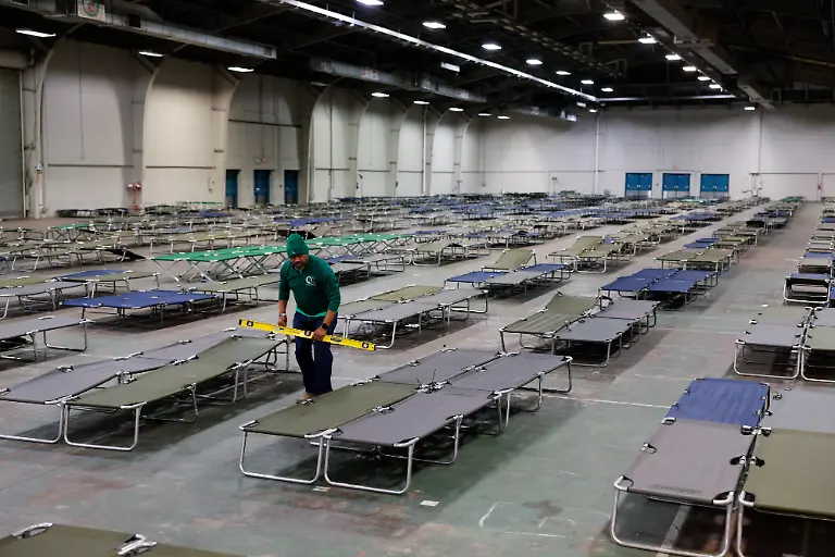 Volunteers-prepare-cots-at-an-inclement-weather-shelter-ahead-of-a-winter-storm-at-Fair-Parks-Automobile-Building-in-Dallas-Texas-US-on-Friday-Jan-23-2026-Texas-Governor-Greg-Abbott-issued-disaster-declarations-for-more-than-half-the-counties-in-the-state-ahead-of-a-powerful-winter-storm-that-will-be-one-of-the-toughest-tests-of-the-electric-grid-since-a-deadly-2021-collapse