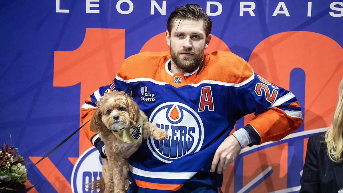 Edmonton-Oilers-Leon-Draisaitl-stands-with-his-dog-before-being-honored-for-his-1000th-point-before-an-NHL-hockey-game-against-the-Los-Angeles-Kings-in-Edmonton-Alberta-Saturday-Jan-10-2026