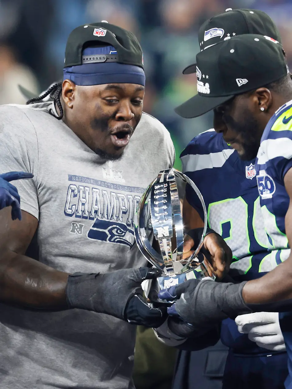 Seattle-Seahawk-players-hold-the-George-Halas-Trophy-after-the-Seahawks-defeated-the-Los-Angeles-Rams-31-27-to-win-their-NFL-Conference-Championship-game-at-Lumen-Field-in-Seattle-Washington-on-Sunday-January-25-2026-The-Seahawks-advance-to-play-the-New-England-Patriots-in-the-Super-Bowl-on-February-8-2026