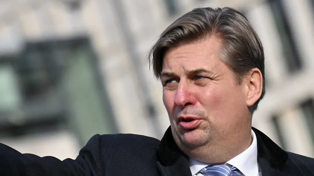 Maximilian-Krah-Alternative-for-Germany-AfD-member-of-the-lower-house-of-parliament-Bundestag-gestures-as-he-watches-pro-Palestinian-activists-not-pictured-who-climbed-atop-Brandenburg-Gate-to-unveil-a-banner-that-reads-Never-again-genocide-Freedom-for-Palestine-in-Berlin-Germany-November-13-2025