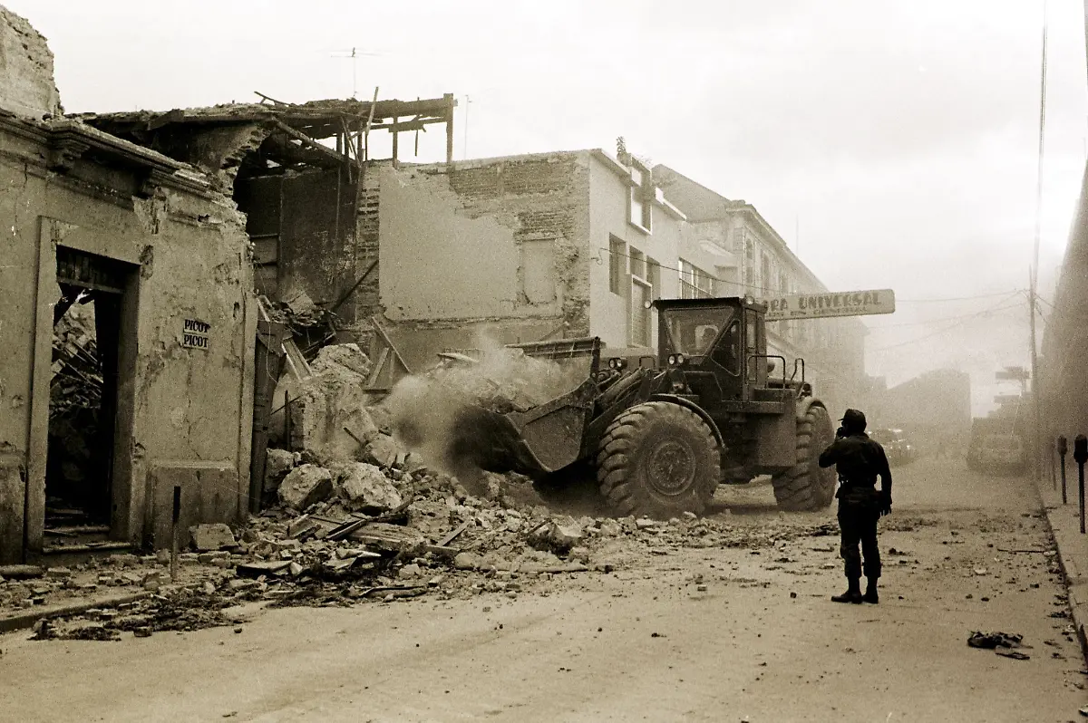 FILES-This-1976-file-photo-shows-a-bulldozer-removing-rubble-left-in-Guatemala-City-by-a-7-9-Richter-scale-earthquake-that-hit-the-city-04-February-1976-The-earthquake-killed-some-26-000-people-dead