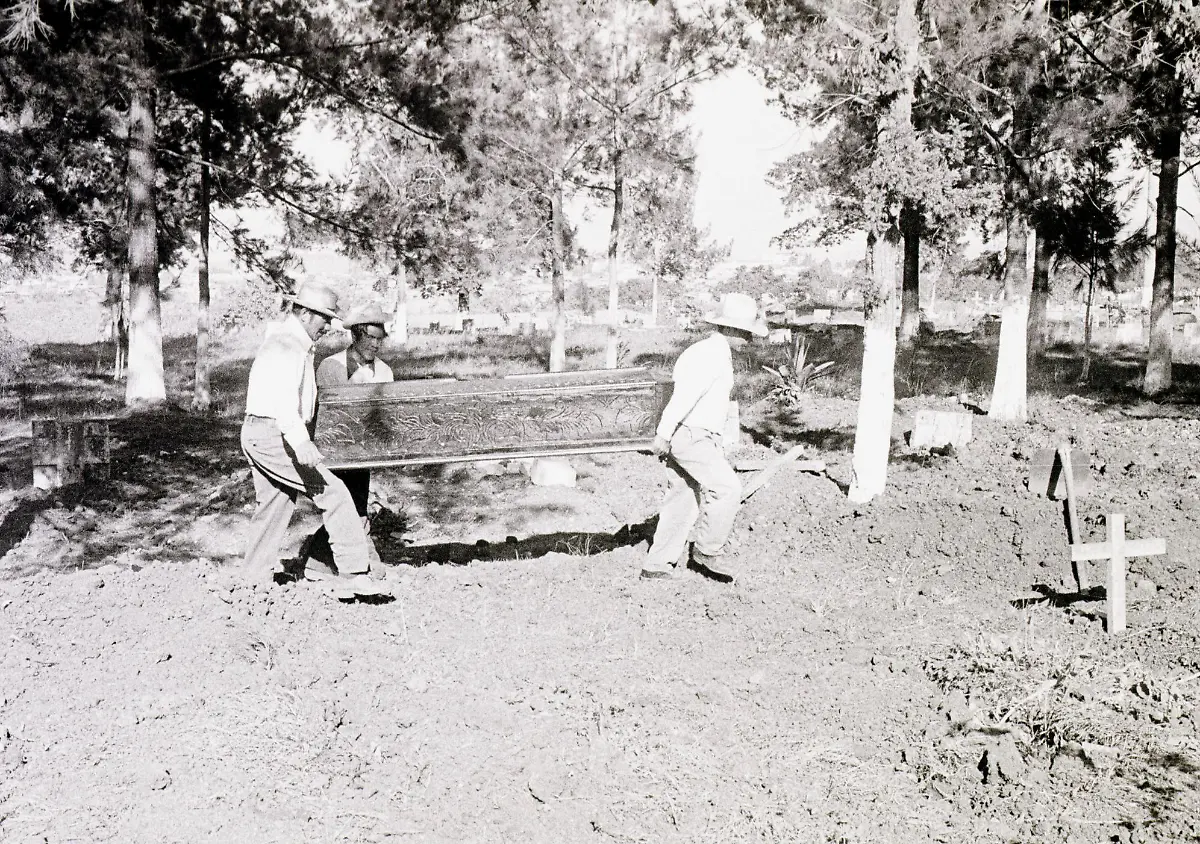 FILES-This-1976-file-photo-shows-workers-at-Guatemala-City-s-La-Verbena-Cemetery-carrying-a-victim-of-the-7-9-Richter-scale-earthquake-that-hit-the-city-04-February-1976-The-earthquake-killed-some-26-000-people-dead