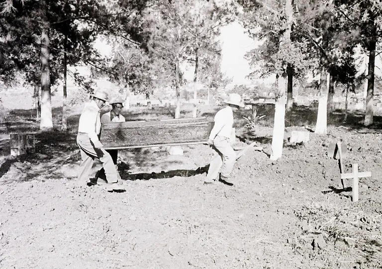 FILES-This-1976-file-photo-shows-workers-at-Guatemala-City-s-La-Verbena-Cemetery-carrying-a-victim-of-the-7-9-Richter-scale-earthquake-that-hit-the-city-04-February-1976-The-earthquake-killed-some-26-000-people-dead