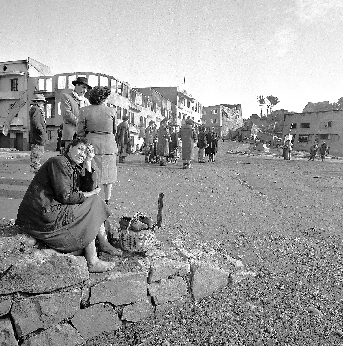 The-tragedy-of-the-earthquake-is-mirrored-in-the-face-of-a-barefoot-woman-sitting-on-a-rock-wall-in-Castro-Chile-May-30-1960-Few-homes-escaped-destruction-in-this-town-of-10-000-persons-AP-Photo-William-J