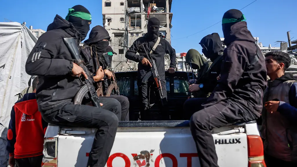 Palestinian-Hamas-militants-arrive-to-secure-the-area-as-Egyptian-workers-accompanied-by-members-of-the-International-Committee-of-the-Red-Cross-ICRC-search-for-the-last-two-remaining-bodies-of-hostages-an-Israeli-soldier-and-a-Thai-national-from-under-the-rubble-of-the-Jabalia-refugee-camp-in-the-northern-of-Gaza-Strip-on-December-1-2025-The-Gaza-war-was-sparked-by-Hamas-s-October-7-2023-attack-on-Israel-resulting-in-the-deaths-of-1-221-people-and-the-taking-251-hostage-Israel-s-retaliatory-assault-on-Gaza-has-killed-over-70-000-people-according-to-figures-from-the-health-ministry-that-the-UN-considers-reliable