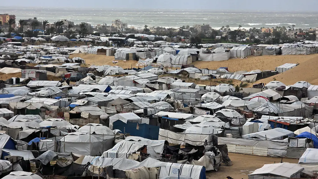 Displaced-Palestinians-fixes-tents-shelter-set-up-in-Khan-Yunis-as-strong-winter-winds-sweep-the-Palestinian-enclave-on-January-13-2026-A-fragile-ceasefire-has-been-in-place-since-October-following-a-deadly-war-waged-by-Israel-in-response-to-Hamas-s-unprecedented-October-7-2023-attack-on-Israel-Nearly-80-percent-of-buildings-in-Gaza-have-been-destroyed-or-damaged-by-the-war-according-to-UN-data