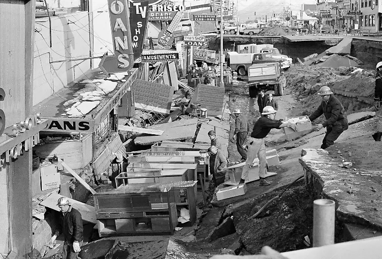 File-In-this-March-30-1964-file-photo-Anchorage-small-business-owners-were-going-full-tilt-clearing-salvagable-items-and-equipment-from-their-earthquake-ravaged-stores-on-shattered-Fourth-Avenue-in-Alaska-in-the-aftermath-of-an-earthquake-North-America-s-largest-earthquake-rattled-Alaska-50-years-ago-killing-15-people-and-creating-a-tsunami-that-killed-124-more-from-Alaska-to-California-The-magnitude-9-2-quake-hit-at-5-30-p-m-on-Good-Friday-turning-soil-beneath-parts-of-Anchorage-into-jelly-and-collapsing-buildings-that-were-not-engineered-to-withstand-the-force-of-colliding-continental-plates