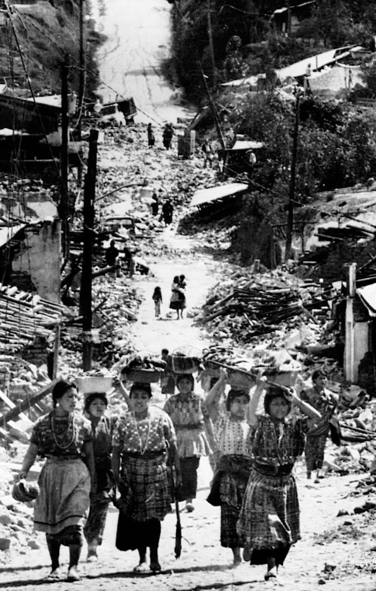 Women-residents-of-San-Pedro-Sacatepequez-walk-up-a-hill-carrying-belongings-they-have-salvaged-amid-the-rubble-of-their-village-on-Feb-9-1976-San-Pedro-was-heavily-damaged-by-a-massive-earthquake-last-week