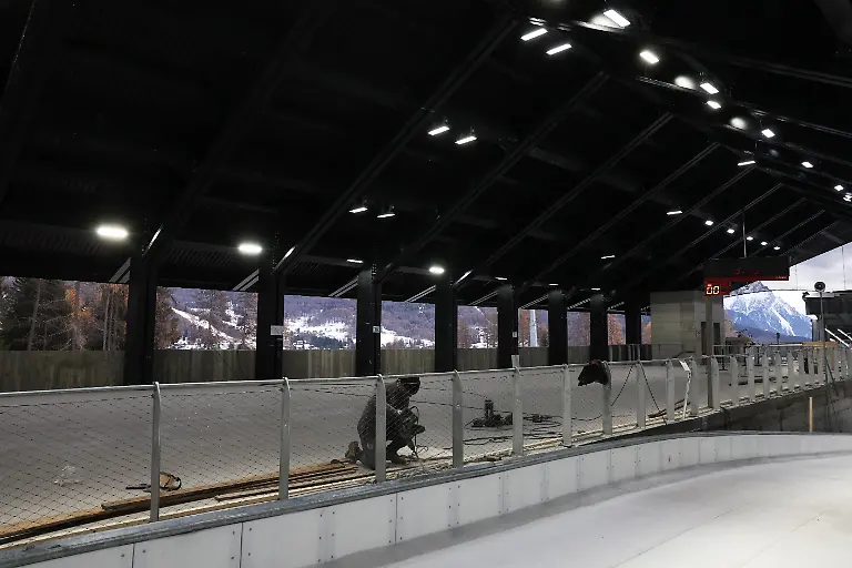 A-man-works-at-Cortina-Sliding-Centre-track-start-house-ahead-of-Milano-Cortina-Winter-Olympics-2026-in-Cortina-d-Ampezzo-Italy-December-4-2025