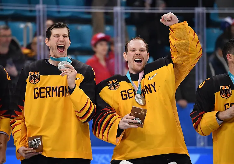 Olympics-Ice-hockey-Eishockey-Men-s-Team-Gold-medal-match-GER-OAR-Feb-24-2018-Gangneung-South-Korea-Germany-goaltender-Danny-Aus-Den-Birken-right-and-forward-Frank-Mauer-left-react-after-receiving-their-silver-medals-after-the-men-s-ice-hockey-gold-medal-match-against-Russia-during-the-Pyeongchang-2018-Olympic-Winter-games-Winterspiele-Spiele-Summer-games-at-Gangneung-Hockey-Centre-Mandatory-Credit-Andrew-Nelles-USA-TODAY-Sports-25-02