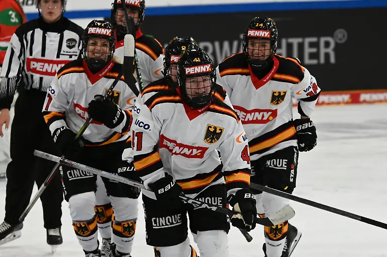 ARCHIV-08-11-2025-Bayern-Landshut-Eishockey-Frauen-Deutschland-Cup-Frauen-Deutschland-Ungarn-4-Spieltag-Mathilda-Heine-2-v-r-faehrt-nach-ihrem-Tor-zum-7-1-Richtung-Bank-Die-erst-16-Jaehrige-steht-auch-im-Olympia-Kader