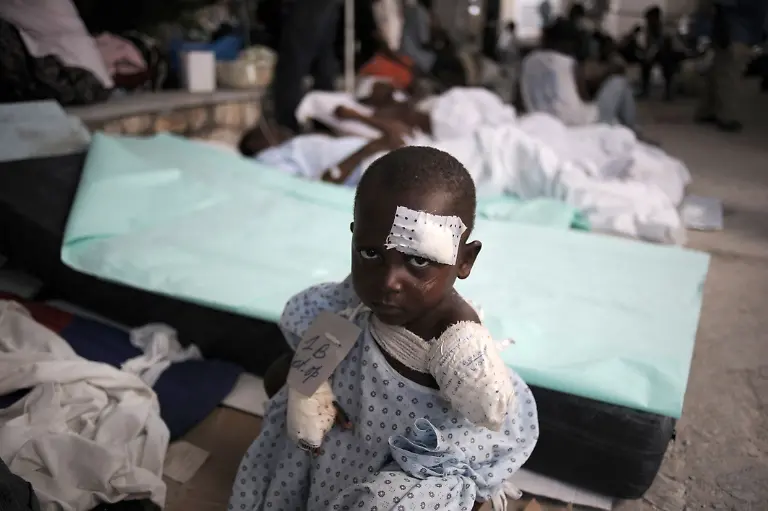 An-earthquake-survivor-sits-on-a-bed-in-a-Medecins-sans-Frontieres-MSF-makeshift-hospital-in-Port-au-Prince-on-January-24-2010-Police-in-the-Haitian-capital-counted-their-losses-and-gathered-their-forces-today-preparing-for-a-surge-in-crime-they-are-certain-will-follow-the-devastating-January-12-earthquake