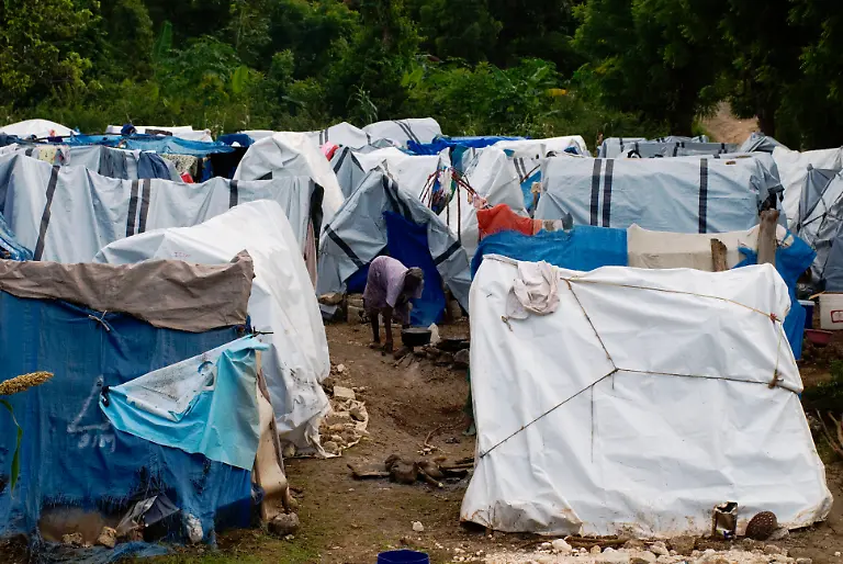 A-woman-cooks-in-a-makeshift-camp-in-the-city-of-Grand-Goave-in-Port-au-Prince-Haiti-on-November-21-2010-This-and-many-other-makeshift-camps-still-stand-10-months-after-the-earthquake-which-devastated-the-country-Photo-by-Juan-Carlos-ABACAUSA