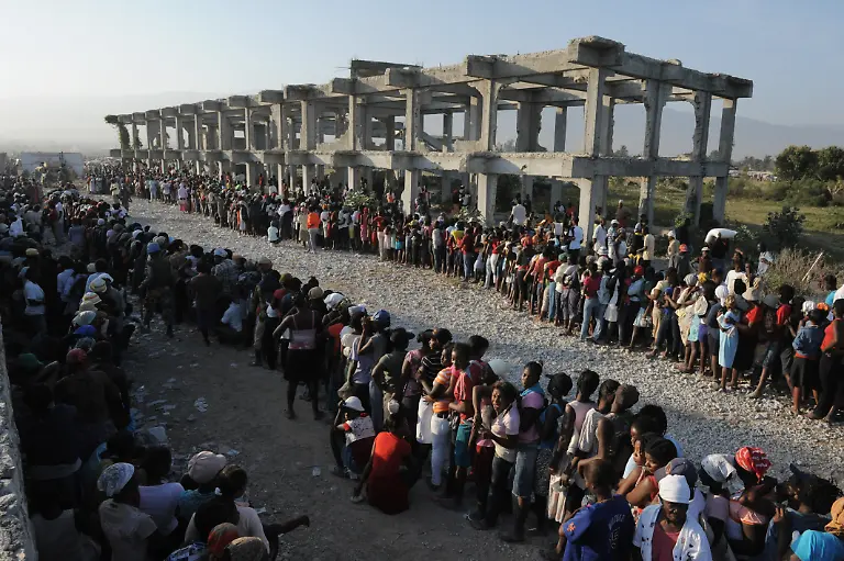 Haitian-women-line-up-to-receive-food-aid-at-a-distribution-point-in-Port-Au-Prince-on-February-14-2010-more-than-a-month-when-a-deadly-earthquake-devastated-the-country-killing-over-200-000-people-and-living-over-one-million-homeless