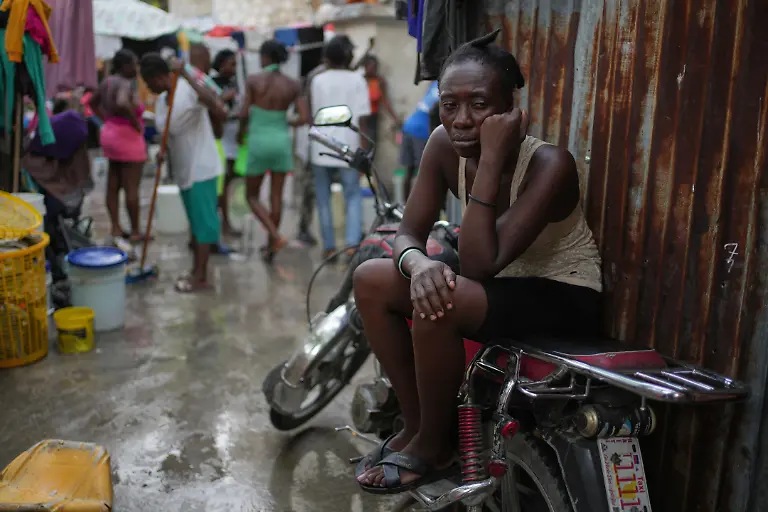 A-woman-rests-while-sitting-on-a-motorcycle-at-a-shelter-for-families-displaced-by-gang-violence-in-Port-au-Prince-Haiti-Thursday-Oct-16-2025