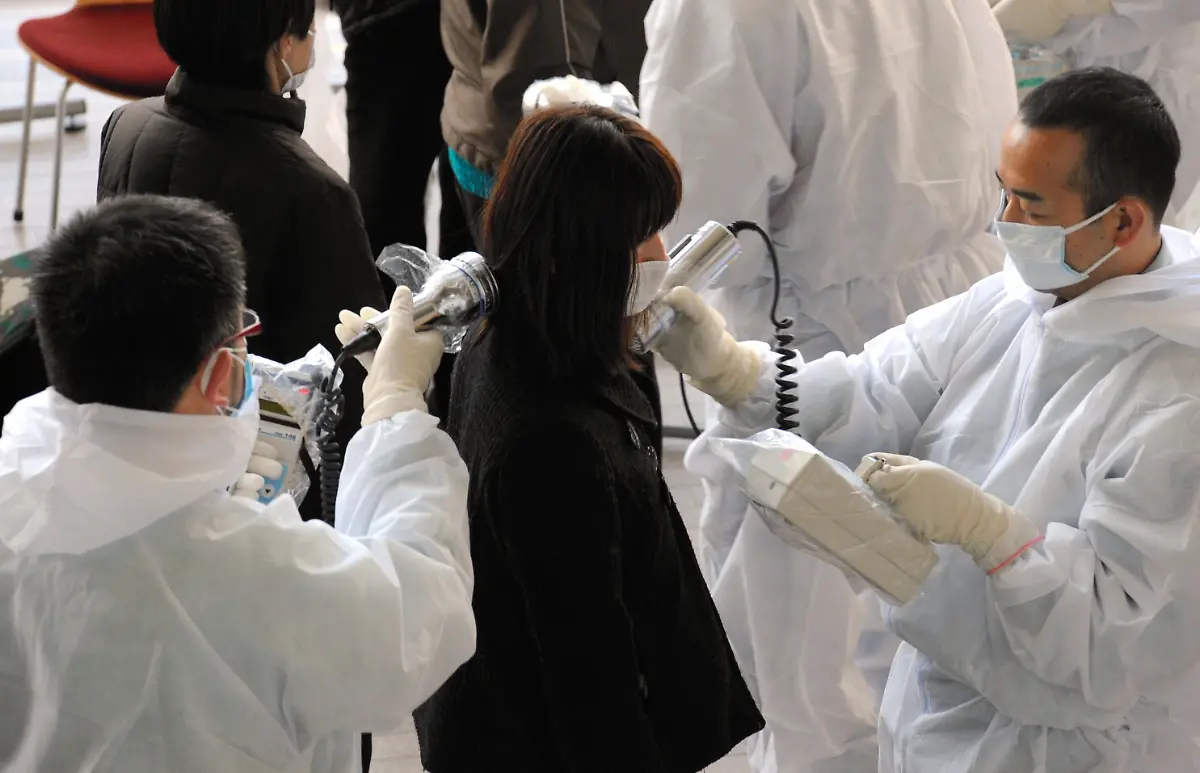 epa02639527-Japanese-medical-personnel-check-a-woman-evacuated-from-her-home-near-the-Fukushima-1-nuclear-plant-for-radiation-exposure-in-Nihonmatsu-Fukushima-prefecture-Japan-18-March-2011-Radiation-levels-at-the-damaged-nuclear-power-plant-in-Fukushima-240-kilometres-north-of-Tokyo-were-rising-well-above-the-legal-limits-top-government-spokesman-Yukio-Edano-said-Reactors-at-the-Fukushima-I-and-II-plants-lost-their-cooling-functions-after-power-and-backup-generators-were-cut-off-by-the-9-0-scale-quake-on-11-March-2011