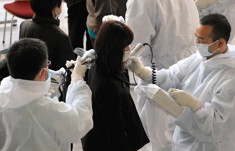 epa02639527-Japanese-medical-personnel-check-a-woman-evacuated-from-her-home-near-the-Fukushima-1-nuclear-plant-for-radiation-exposure-in-Nihonmatsu-Fukushima-prefecture-Japan-18-March-2011-Radiation-levels-at-the-damaged-nuclear-power-plant-in-Fukushima-240-kilometres-north-of-Tokyo-were-rising-well-above-the-legal-limits-top-government-spokesman-Yukio-Edano-said-Reactors-at-the-Fukushima-I-and-II-plants-lost-their-cooling-functions-after-power-and-backup-generators-were-cut-off-by-the-9-0-scale-quake-on-11-March-2011