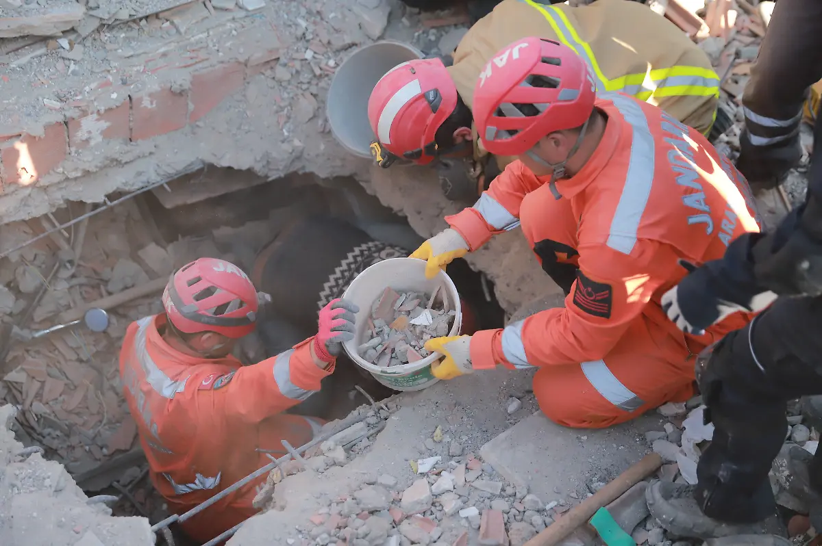 Search-and-rescue-teams-are-working-on-a-destroyed-building-at-Iskenderun-city-in-Hatay-south-Turkey-Powerful-earthquakes-7-8-and-7-6-have-hit-a-wide-area-in-south-eastern-Turkey-near-the-Syrian-border-on-6th-of-February-killing-more-than-15000-people-and-trapping-many-others-Hatay-Turkey-February-8-2023-Photo-by-Berkcan-Zengin-Depo-Photos-ABACAPRESS