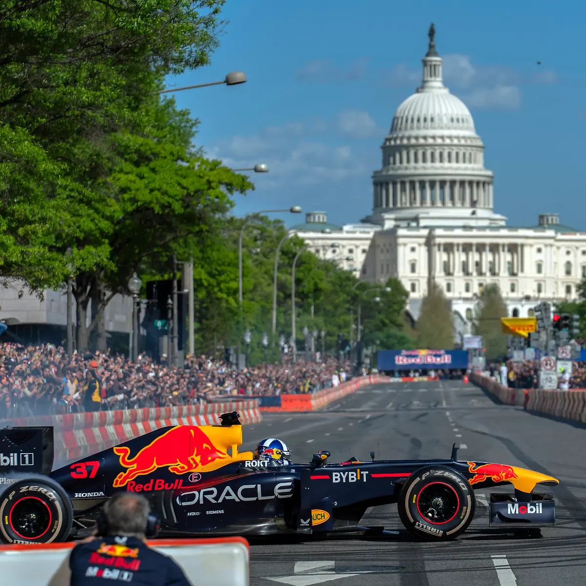 Whit-the-U-S-Capitol-in-the-background-former-Grand-Prix-winning-driver-David-Coulthard-waves-to-the-crowd-as-he-drives-the-RB7-racing-car-that-won-the-2011-Formula-One-Title-during-the-Showrun-DC-demonstration-on-Pennsylvania-Avenue-in-Washington-Saturday-April-20-2024