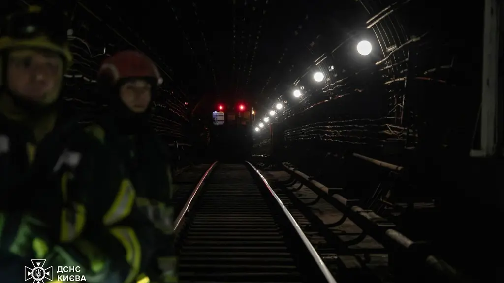 This-handout-photograph-taken-and-released-by-the-State-Emergency-Service-of-Ukraine-on-January-31-2026-shows-rescuers-helping-people-to-leave-subway-through-tunnels-during-mass-power-outages-in-Kyiv-amid-the-Russian-invasion-of-Ukraine-According-to-the-emergency-services-rescuers-evacuated-almost-500-people-during-the-forced-stop-of-metro-trains