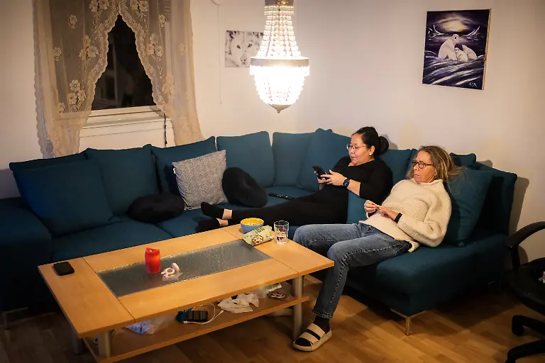 Danish-teacher-Vanilla-Mathiassen-sits-with-her-friend-on-a-sofa-at-a-house-in-Kapisillit-Greenland-January-20-2026-People-here-are-interested-in-the-day-that-is-coming-Is-there-food-in-the-fridge-Fine-then-I-can-sleep-a-little-longer-If-there-is-no-food-then-I-will-go-out-and-catch-fish-or-go-out-and-shoot-a-reindeer-said-Vanilla-Mathiassen-a-Danish-teacher-in-Kapisillit-who-has-worked-in-towns-and-villages-across-Greenland-for-13-years-REUTERS-Marko-Djurica-SEARCH-DJURICA-GREENLAND-INUIT-FOR-THIS-STORY-SEARCH-WIDER-IMAGE-FOR-ALL-STORIES