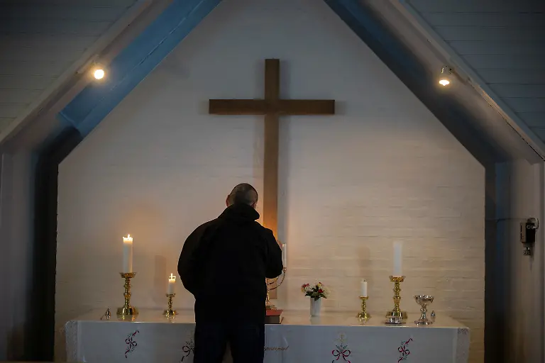 The-village-catechist-Kaaleeraq-Ringsted-74-lights-candles-inside-the-church-in-Kapisillit-Greenland-January-20-2026-The-concept-that-ownership-is-shared-collectively-is-central-to-the-Inuit-identity-It-has-survived-300-years-of-colonisation-and-is-written-into-law-People-can-own-houses-but-not-the-land-beneath-them-We-can-t-even-buy-our-own-land-ourselves-but-Trump-wants-to-buy-it-that-s-so-strange-to-us-said-Ringsted-REUTERS-Marko-Djurica-SEARCH-DJURICA-GREENLAND-INUIT-FOR-THIS-STORY-SEARCH-WIDER-IMAGE-FOR-ALL-STORIES