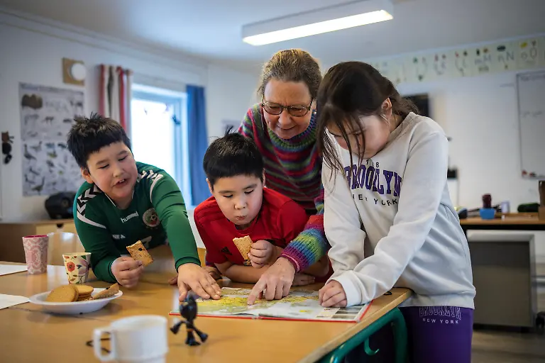Danish-teacher-Vanilla-Mathiassen-teaches-William-8-Malerak-7-and-Viola-7-the-only-remaining-students-a-map-of-Greenland-printed-in-1954-inside-a-classroom-at-the-school-in-Kapisillit-Greenland-January-20-2026-At-the-school-these-are-the-only-three-remaining-students-studying-beneath-a-map-of-Greenland-printed-in-1954-During-recess-they-go-sledding-All-three-are-moving-away-soon-and-the-school-may-close-REUTERS-Marko-Djurica-SEARCH-DJURICA-GREENLAND-INUIT-FOR-THIS-STORY-SEARCH-WIDER-IMAGE-FOR-ALL-STORIES