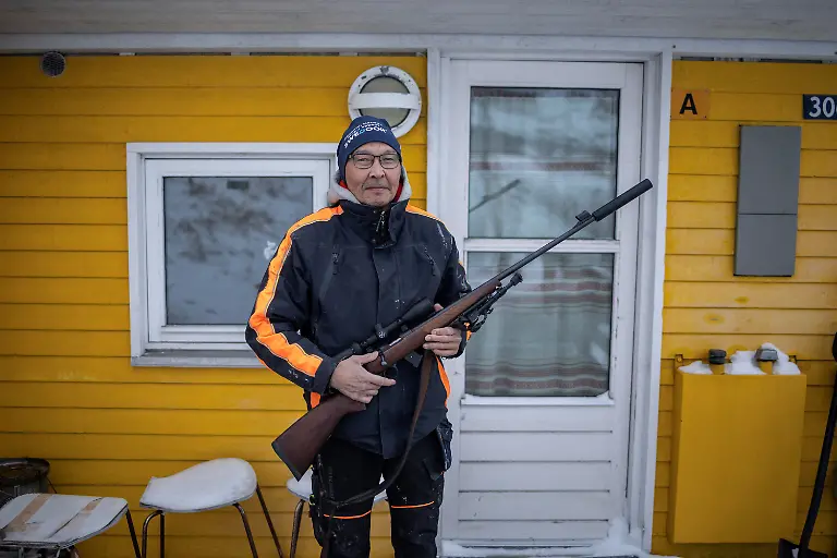 Johannes-Hansen-poses-with-his-hunting-rifle-in-Kapisillit-Greenland-January-21-2026-People-here-are-interested-in-the-day-that-is-coming-Is-there-food-in-the-fridge-Fine-then-I-can-sleep-a-little-longer-If-there-is-no-food-then-I-will-go-out-and-catch-fish-or-go-out-and-shoot-a-reindeer-said-Vanilla-Mathiassen-a-Danish-teacher-in-Kapisillit-who-has-worked-in-towns-and-villages-across-Greenland-for-13-years-REUTERS-Marko-Djurica-SEARCH-DJURICA-GREENLAND-INUIT-FOR-THIS-STORY-SEARCH-WIDER-IMAGE-FOR-ALL-STORIES
