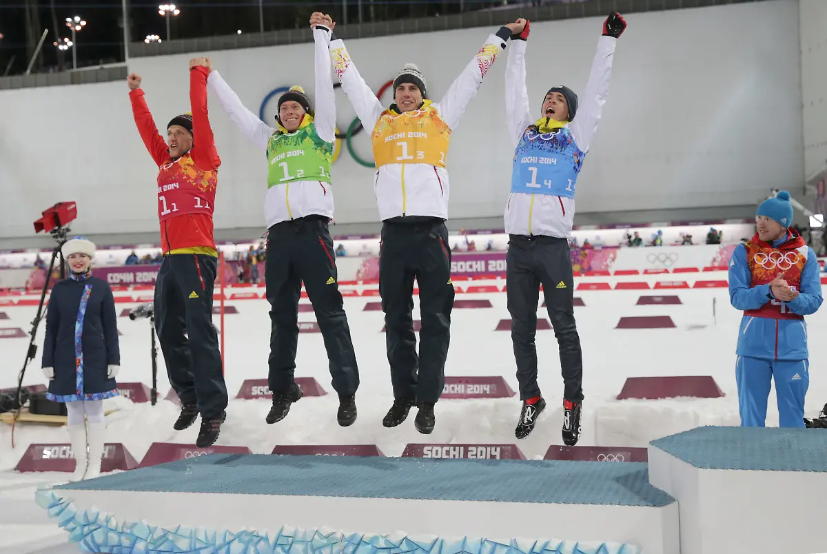 L-R-Silver-medalists-Erik-Lesser-Daniel-Boehm-Arnd-Peiffer-and-Simon-Schempp-of-Germany-and-German-coach-Fritz-Fischer-celebrate-during-the-medal-ceremony-of-the-Biathlon-Men-s-4x7-5km-Relay-in-Laura-Cross-country-Ski-Biathlon-Center-at-the-Sochi-2014-Olympic-Games-Krasnaya-Polyana-Russia-22-February-2014
