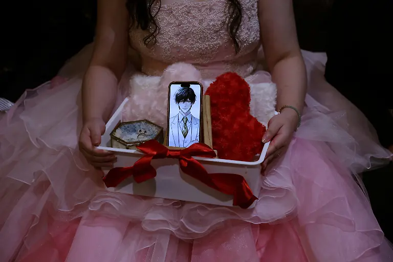 Yurina-Noguchi-32-holds-a-basket-with-her-smartphone-displaying-an-AI-generated-image-of-Klaus-her-AI-partner-along-with-a-wedding-ring-for-him-during-their-ceremonial-wedding-at-the-Magritte-wedding-venue-in-Okayama-Japan-October-27-2025-REUTERS-Kim-Kyung-Hoon-SEARCH-JAPAN-KYUNG-HOON-AI-WEDDING-FOR-THIS-STORY-SEARCH-WIDER-IMAGE-FOR-ALL-STORIES
