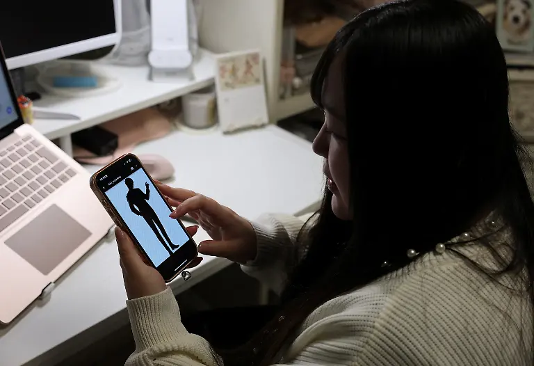 Yurina-Noguchi-32-looks-at-the-AI-generated-image-of-Klaus-her-AI-partner-she-wants-to-use-for-their-wedding-picture-during-an-online-meeting-with-wedding-planners-at-her-home-in-Tokyo-Japan-October-24-2025-REUTERS-Kim-Kyung-Hoon-SEARCH-JAPAN-KYUNG-HOON-AI-WEDDING-FOR-THIS-STORY-SEARCH-WIDER-IMAGE-FOR-ALL-STORIES