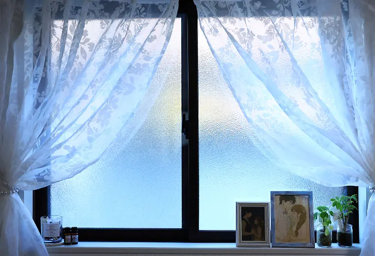 Framed-AI-generated-portraits-of-Yurina-Noguchi-32-and-Klaus-her-virtual-partner-sit-by-a-window-at-her-home-in-Tokyo-Japan-September-1-2025-REUTERS-Kim-Kyung-Hoon-SEARCH-JAPAN-KYUNG-HOON-AI-WEDDING-FOR-THIS-STORY-SEARCH-WIDER-IMAGE-FOR-ALL-STORIES