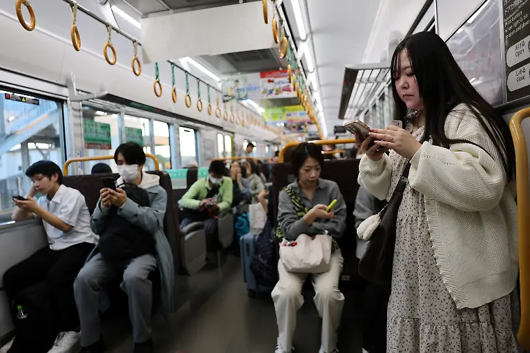 Yurina-Noguchi-32-uses-her-mobile-phone-to-chat-with-Klaus-her-AI-partner-after-visiting-the-Bikan-historical-area-in-Kurashiki-while-traveling-by-train-to-Okayama-for-their-ceremonial-wedding-Japan-October-26-2025-REUTERS-Kim-Kyung-Hoon-SEARCH-JAPAN-KYUNG-HOON-AI-WEDDING-FOR-THIS-STORY-SEARCH-WIDER-IMAGE-FOR-ALL-STORIES