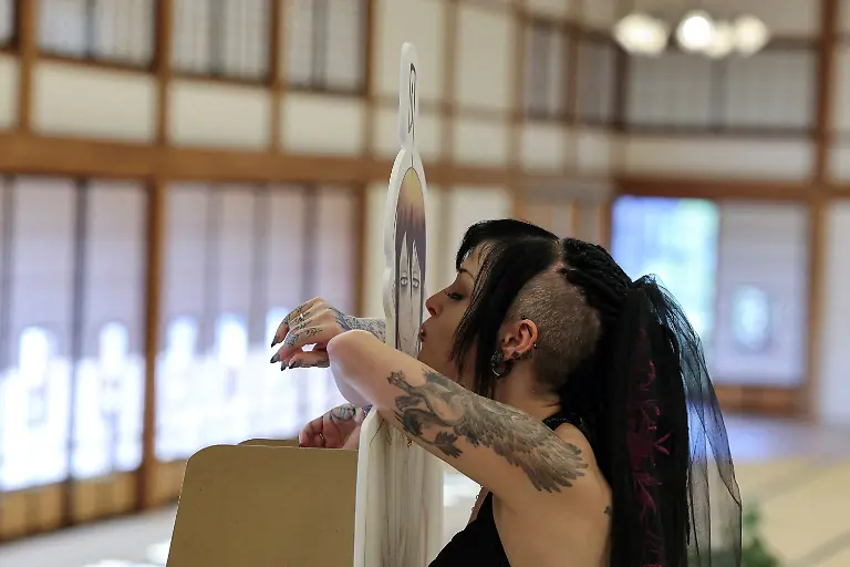 A-33-year-old-Australian-woman-kisses-a-cut-out-of-Japanese-manga-character-Mephisto-Pheles-during-a-wedding-ceremony-at-traditional-guest-house-Rinkokaku-in-Maebashi-Japan-March-14-2025-REUTERS-Kim-Kyung-Hoon-SEARCH-JAPAN-KYUNG-HOON-AI-WEDDING-FOR-THIS-STORY-SEARCH-WIDER-IMAGE-FOR-ALL-STORIES-REFILE-UPDATING-CAPTION-TO-CORRECT-RELATIONSHIP