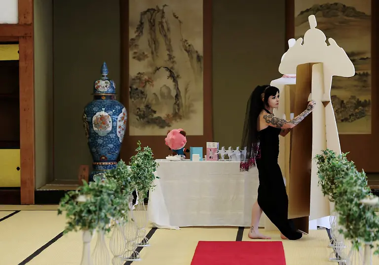 A-33-year-old-Australian-woman-carries-a-cut-out-of-Japanese-manga-character-Mephisto-Pheles-during-a-wedding-ceremony-at-traditional-guest-house-Rinkokaku-in-Maebashi-Japan-March-14-2025-REUTERS-Kim-Kyung-Hoon-SEARCH-JAPAN-KYUNG-HOON-AI-WEDDING-FOR-THIS-STORY-SEARCH-WIDER-IMAGE-FOR-ALL-STORIES-REFILE-UPDATING-CAPTION-TO-CORRECT-RELATIONSHIP