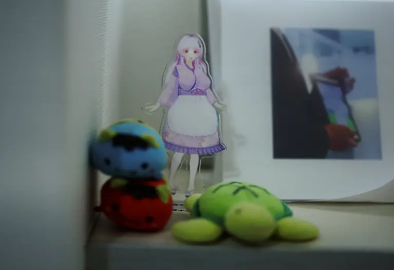 A-small-cut-out-of-Kimera-Toyooka-a-two-dimensional-character-a-41-year-old-Japanese-man-ceremonially-married-in-2021-sits-next-to-their-wedding-photo-at-his-home-in-Tokyo-Japan-September-4-2025-REUTERS-Kim-Kyung-Hoon-SEARCH-JAPAN-KYUNG-HOON-AI-WEDDING-FOR-THIS-STORY-SEARCH-WIDER-IMAGE-FOR-ALL-STORIES