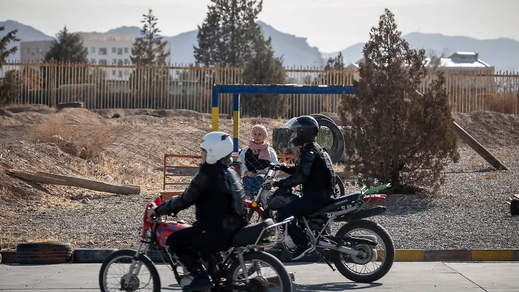 A-young-Iranian-female-motorcyclist-looks-at-women-participating-in-a-training-session-at-the-Motorex-Motorcycle-Training-School-in-a-sports-complex-in-Tehran-Iran-on-February-2-2026-The-Iranian-government-officially-approves-the-issuance-of-motorcycle-licenses-for-women-47-years-after-the-victory-of-Iran-s-Islamic-Revolution