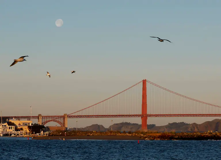 An-almost-full-moon-sets-behind-the-Golden-Gate-Bridge-after-sunrise-in-San-Francisco-on-Tuesday-February-3-2026-The-New-England-Patriots-will-play-the-Seattle-Seahawks-in-Super-Bowl-LX-at-Levi-s-Stadium-in-Santa-Clara-on-Sunday-February-8-2026