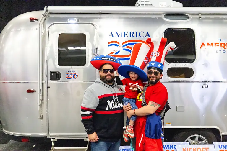 SAN-FRANCISCO-CA-FEBRUARY-04-Attendees-pose-for-a-photo-in-front-of-an-America250-trailer-at-the-NFL-American-Football-Herren-USA-Super-Bowl-LX-Experience-on-February-4-2026-at-the-Moscone-Center-in-San-Francisco-CA