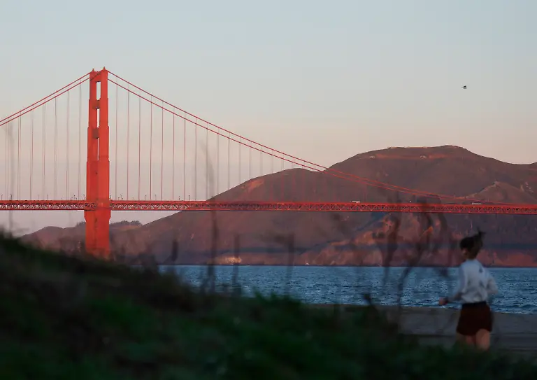 A-runner-jogs-in-Crissy-Field-with-a-view-of-the-Golden-Gate-Bridge-after-sunrise-in-San-Francisco-on-Tuesday-February-3-2026-The-New-England-Patriots-will-play-the-Seattle-Seahawks-in-Super-Bowl-LX-at-Levi-s-Stadium-in-Santa-Clara-on-Sunday-February-8-2026