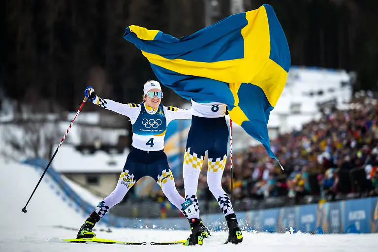 260207-Ebba-Andersson-and-Frida-Karlsson-of-Sweden-celebrate-after-the-women-s-20-km-cross-country-skiing-skiathlon-during-day-1-of-the-2026-Winter-Olympics-on-February-7-2026-in-Val-di-Fiemme