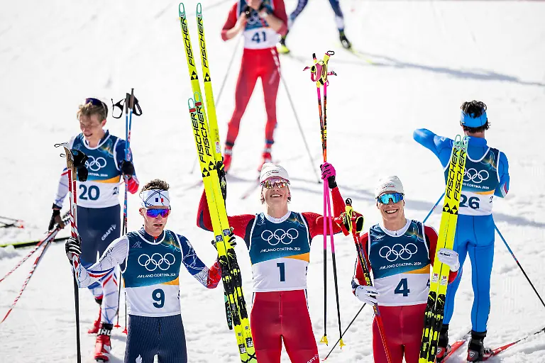 260208-Mathis-Desloges-of-France-Johannes-Hosflot-Klaebo-of-Norway-and-Martin-Lowstrom-Nyenget-of-Norway-celebrate-after-the-men-s-20-km-cross-country-skiing-skiathlon-during-day-2-of-the-2026-Winter-Olympics-on-February-8-2026-in-Val-di-Fiemme