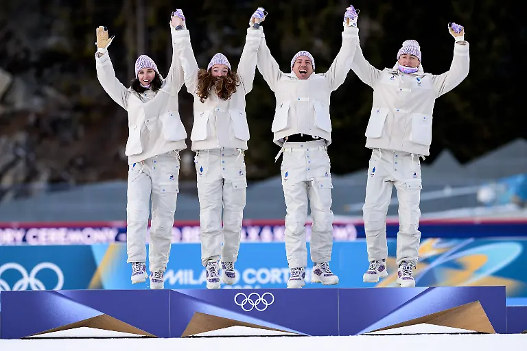 260208-Julia-Simon-Lou-Jeanmonnot-Eric-Perrot-and-Quentin-Fillon-Maillet-of-France-celebrate-on-the-podium-after-competing-in-biathlon-mixed-relay-during-day-2-of-the-2026-Winter-Olympics-on-February-8-2026-in-Anterselva