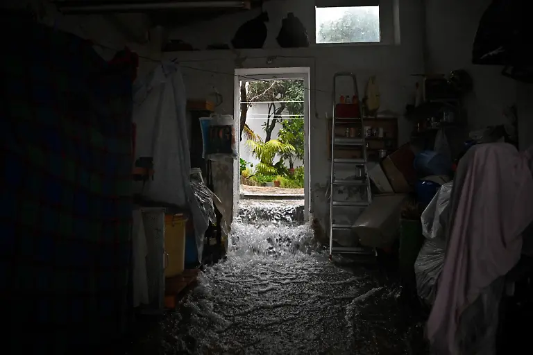 Water-flows-through-a-flooded-house-in-Grazalema-southern-Spain-on-February-5-2026-amid-Storm-Leonardo-Spain-today-lifted-its-highest-weather-alert-for-torrential-rain-in-the-southern-region-of-Andalusia-where-a-woman-went-missing-a-day-after-the-storm-killed-one-in-Portugal-Storm-Leonardo-dumped-more-than-40-centimetres-15-inches-of-rain-in-some-Andalusian-districts-yesterday-forcing-the-evacuation-of-thousands-paralysing-rail-and-road-transport-and-shutting-schools-The-downpours-which-came-after-a-storm-killed-five-people-and-left-hundreds-injured-in-neighbouring-Portugal-last-week-are-examples-of-extreme-weather-that-scientists-say-climate-change-is-worsening