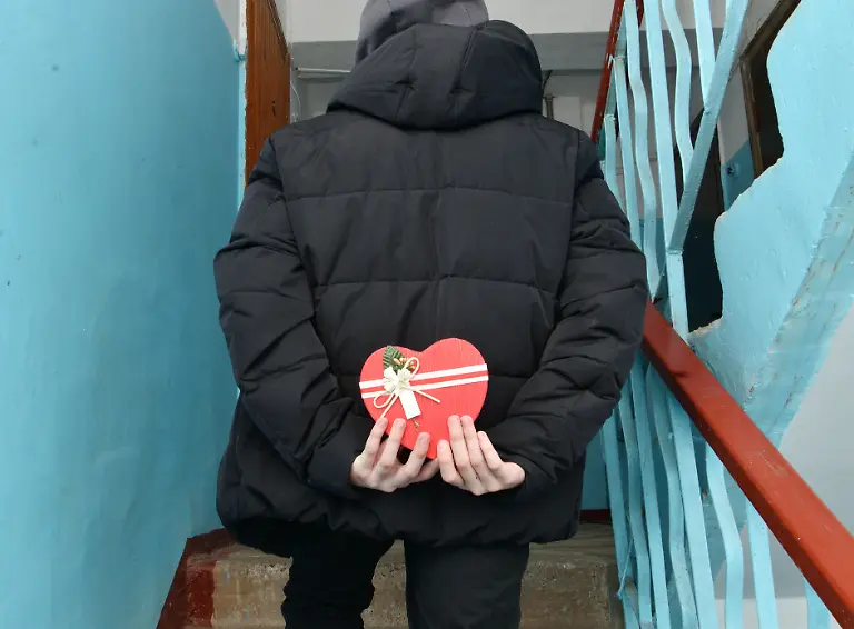 On-Valentine-s-Day-a-boy-holds-a-gift-behind-his-back