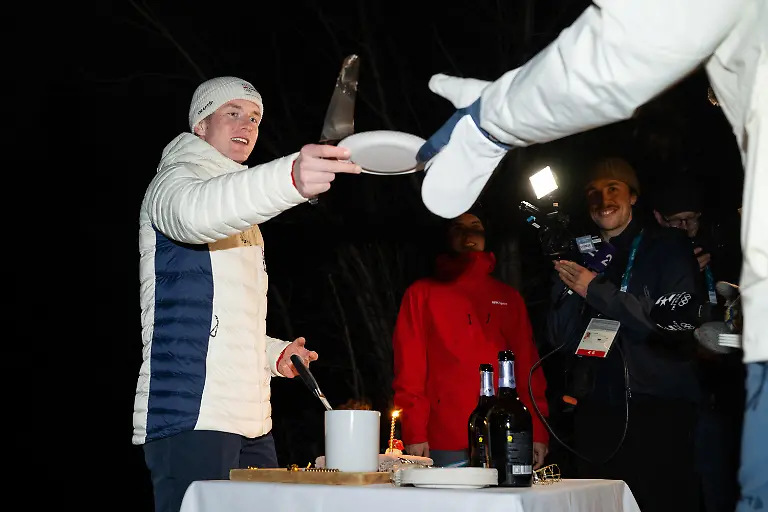260210-Johan-Olav-Botn-of-the-Norwegian-national-biathlon-team-on-a-medal-hands-out-cake-at-a-celebration-for-men-s-biathlon-20-km-individual-during-day-4-of-the-2026-Winter-Olympics-on-February-10-2026-in-Anterselva