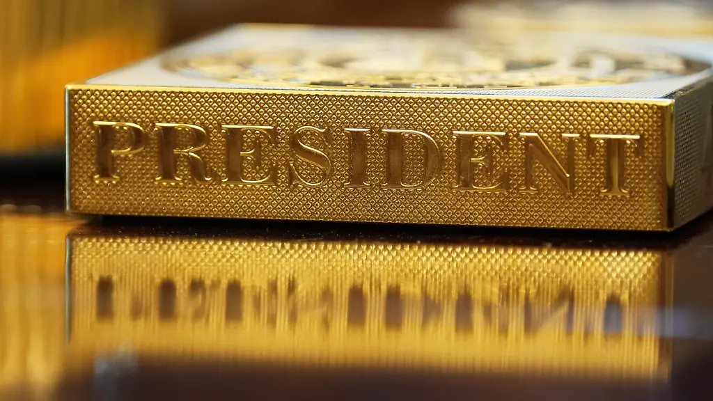 FILE-A-gold-colored-item-embossed-with-the-word-President-sits-on-the-Resolute-desk-in-the-Oval-Office-of-the-White-House-in-Washington-Nov-10-2025