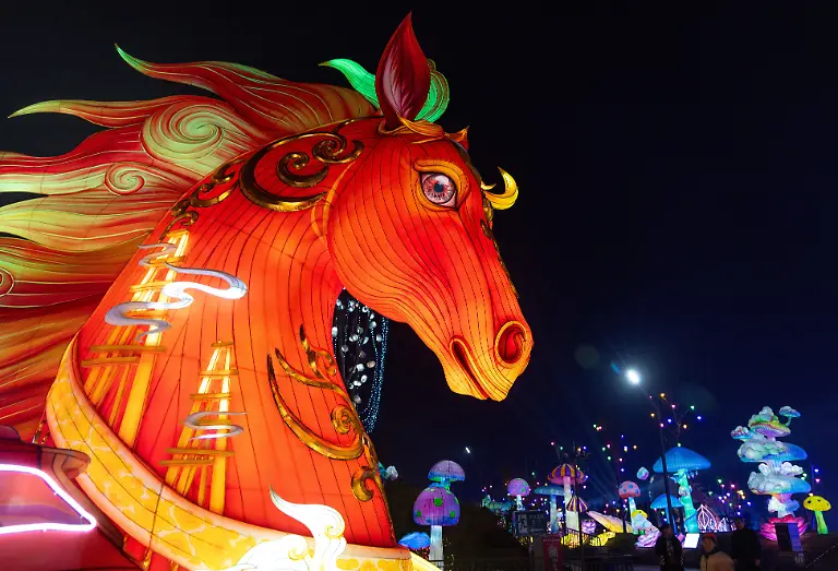 People-walk-next-to-a-light-installation-depicting-a-horse-at-the-32nd-Zigong-International-Lantern-Festival-ahead-of-the-Chinese-Lunar-New-Year-which-will-welcome-the-Year-of-the-Horse-in-Zigong-Sichuan-province-China-January-23-2026